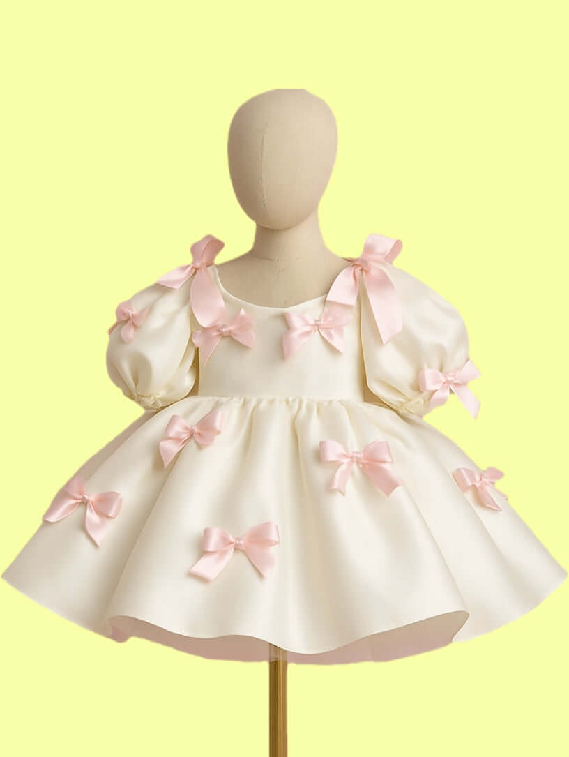 Pink Bow Dream Dress featuring satin puff sleeves and delicate pink bows for girls' parties.